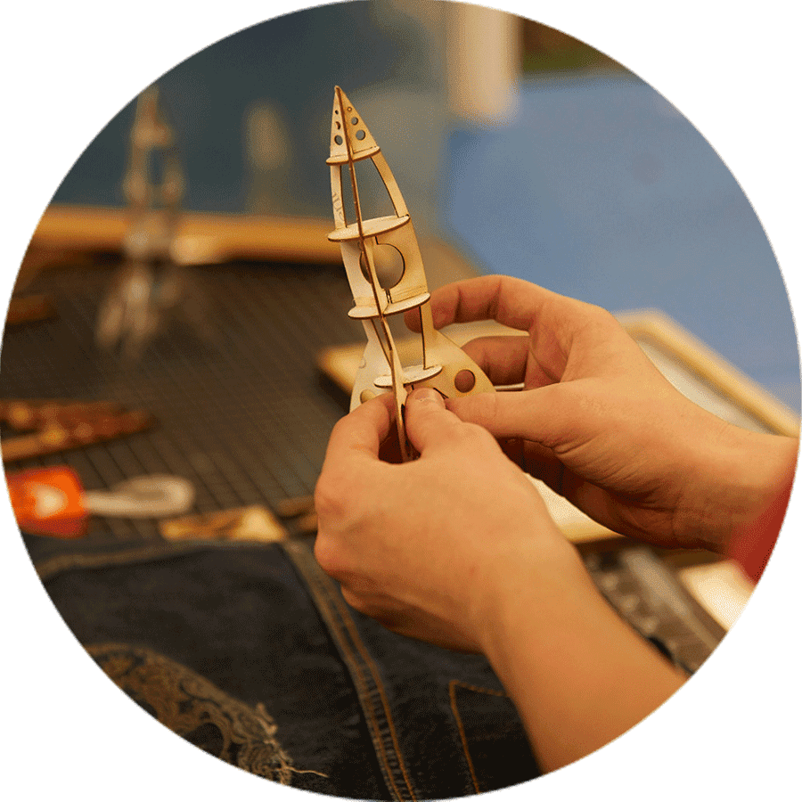 student building a small rocket of wood