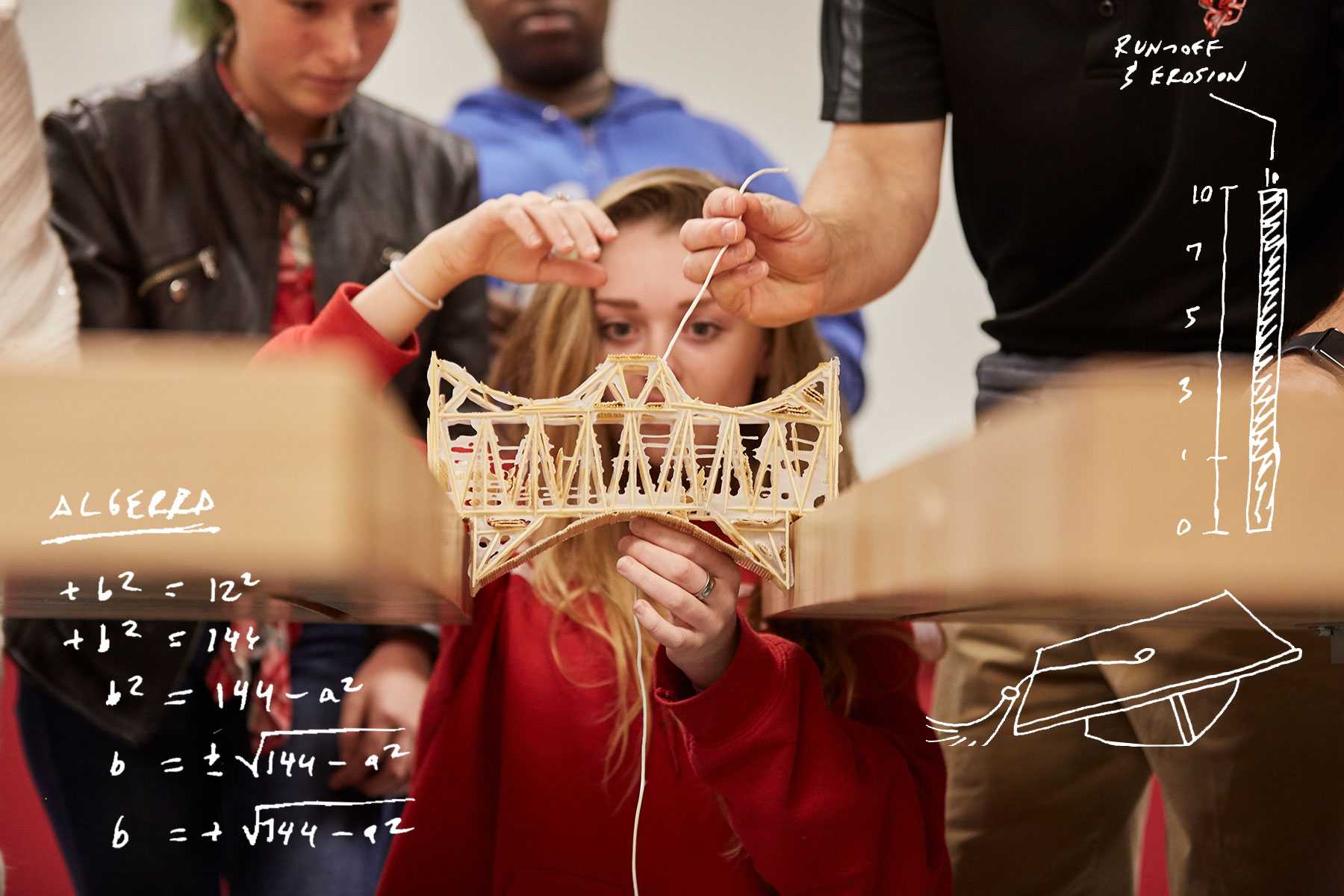 students building a small model of a bridge