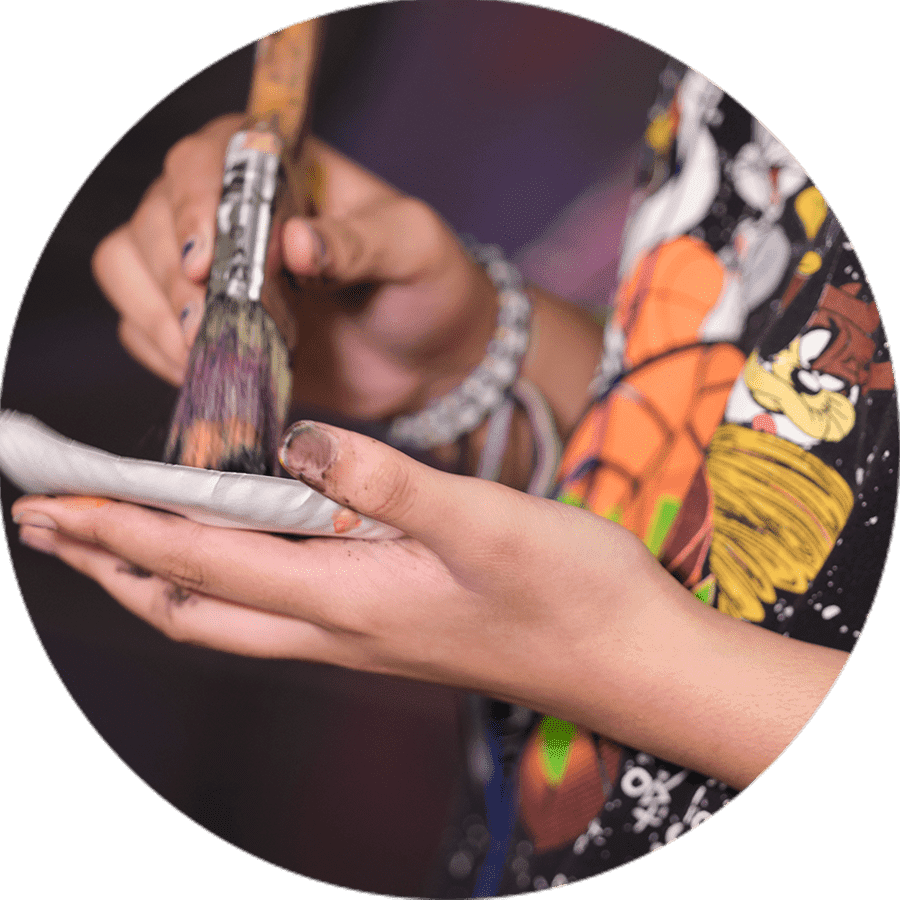 a student using a paintbrush