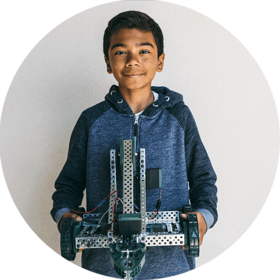 student smiling holding a project